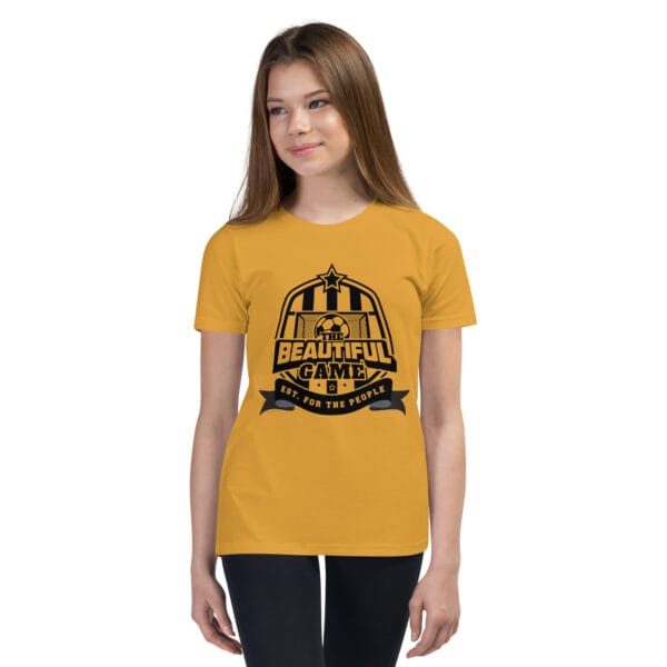 Girl in a mustard staple t-shirt with a black The Beautiful Game crest, est. for the people