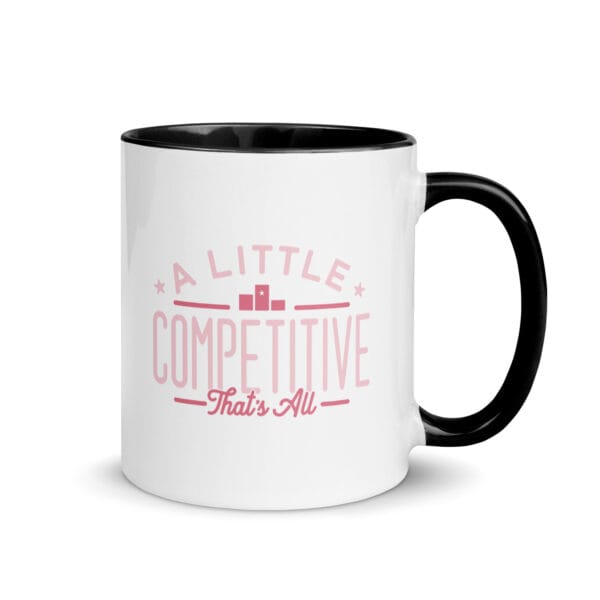 A 11oz white ceramic mug with black colour inside and handle and text saying 'A little competitive, that's all' in pink