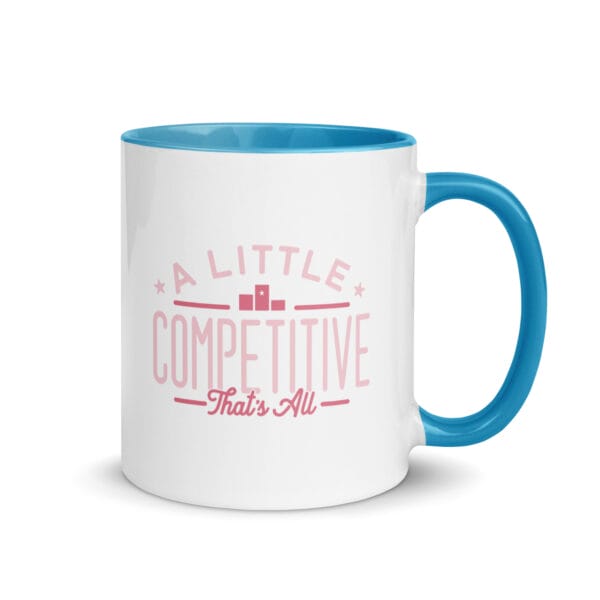 A 11oz white ceramic mug with blue colour inside/handle and text saying 'A little competitive, that's all' in pink