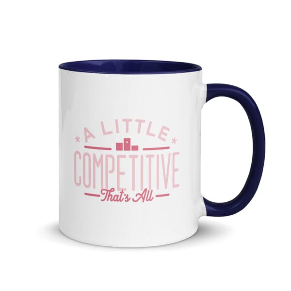 A 11oz white ceramic mug with dark blue colour inside/handle and text saying 'A little competitive, that's all' in pink