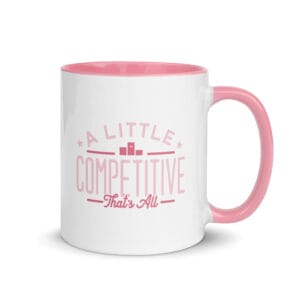 A 11oz white ceramic mug with pink colour inside/handle and text saying 'A little competitive, that's all' in pink