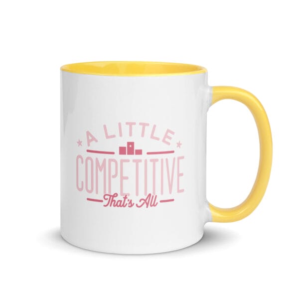 A 11oz white ceramic mug with yellow colour inside/handle and text saying 'A little competitive, that's all' in pink