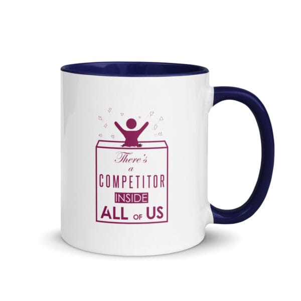 white ceramic mug with dark blue colour inside, purple text "There's a competitor inside us all" with girl bursting out of a box