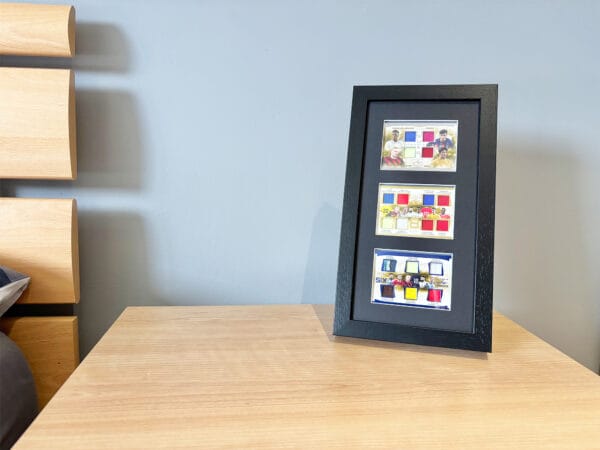 Football memorabilia display case standing using optional leg stand, 18 game-worn relics, including Messi, Ronaldo, Haaland