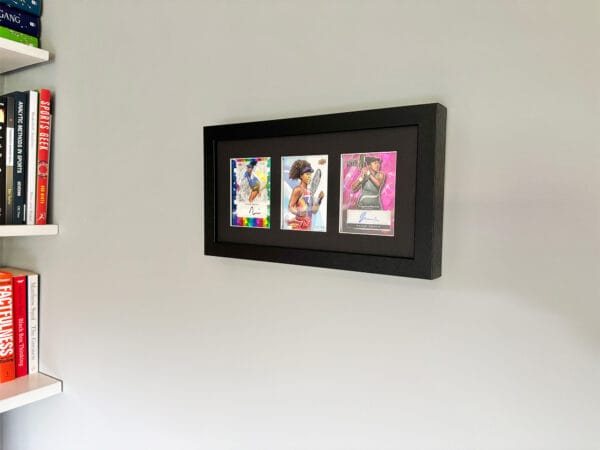 Naomi Osaka memorabilia black display case hanging on the wall, Osaka two autographs
