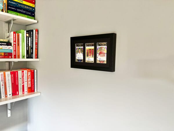 Michael Owen memorabilia display case hanging on wall, three autographs from Owen, including rare 1 of 1