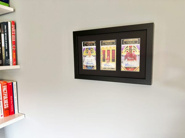 Michael Owen memorabilia display case hanging on wall, three autographs from Owen, including rare 1 of 1