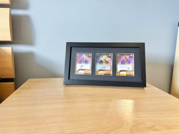 PSG memorabilia display with Barcola, Ramos and Dembele autographs on bedside table using optional leg stand