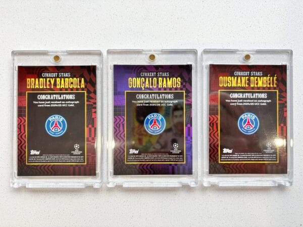 Three PSG sports trading cards from the back with Barcola, Ramos and Dembele autographs