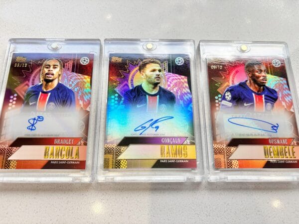 Three PSG sports trading cards from the front with Barcola, Ramos and Dembele autographs