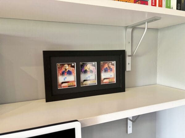 PSG Autographs from Barcola, Ramos and Dembele autographs in black display case standing upright on shelf