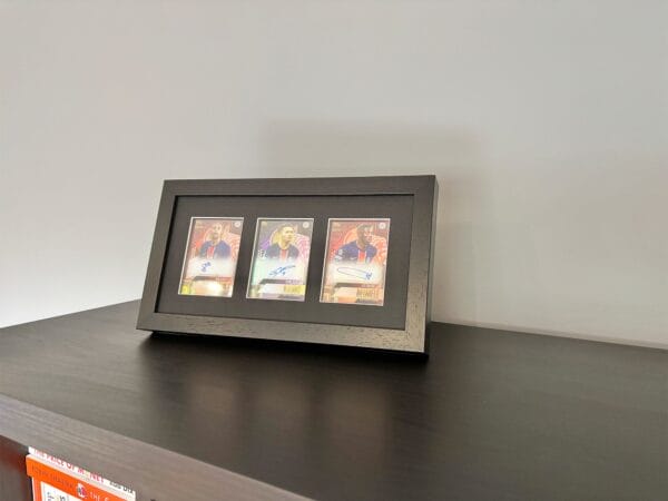 PSG memorabilia black display with Barcola, Ramos and Dembele autographs on surface using optional leg stand