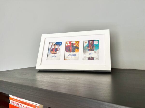 Barcelona 125th Anniversary memorabilia display, white frame, three signed sports cards from Victor, Rivaldo and Olmo, standing using optional leg stand