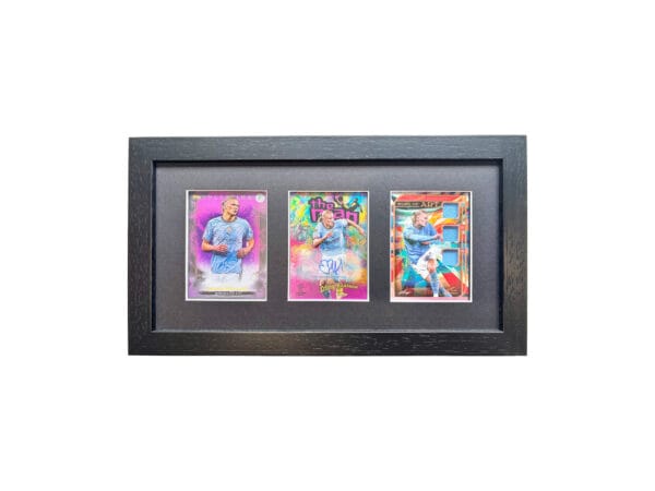 Erling Haaland autograph and relic display, black frame holding three sports cards